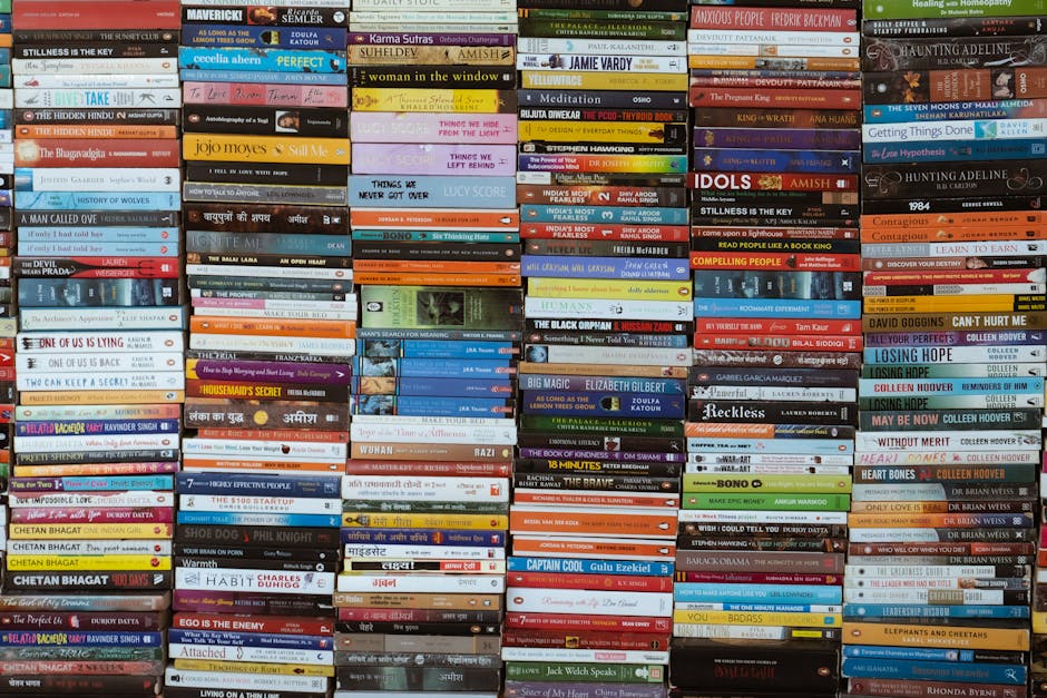 Vibrant collection of books stacked in a Delhi market, showcasing diverse titles and authors.