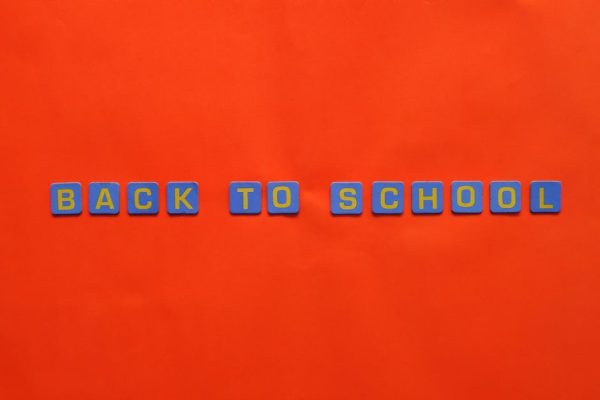 Bright back to school text with blocks on vivid red. Educational theme.