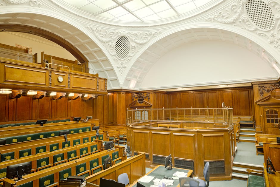 Interior view of a historic courtroom in London with ornate design and wooden furnishing.