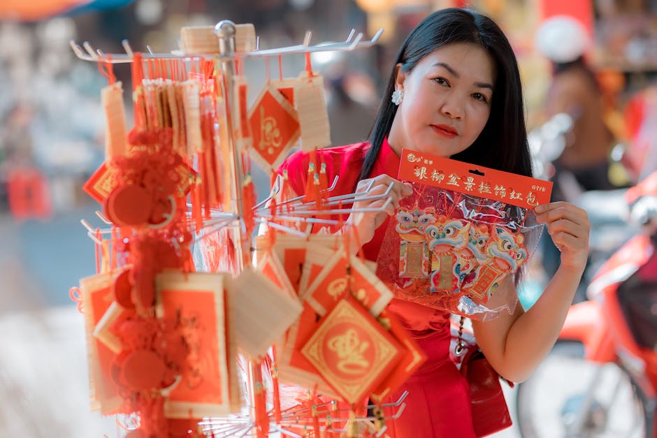 Woman holding traditional Lunar New Year decorations in an outdoor market.