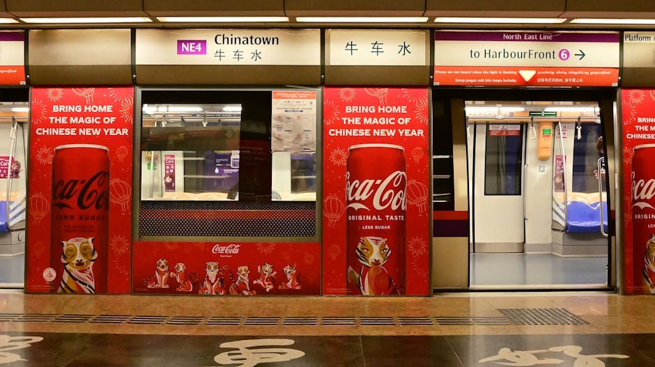 Chinatown MRT adorned with festive Coca-Cola ads for Chinese New Year in Singapore.