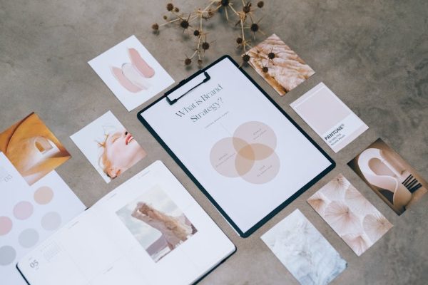Flat lay of a minimalist brand strategy moodboard on a concrete surface.