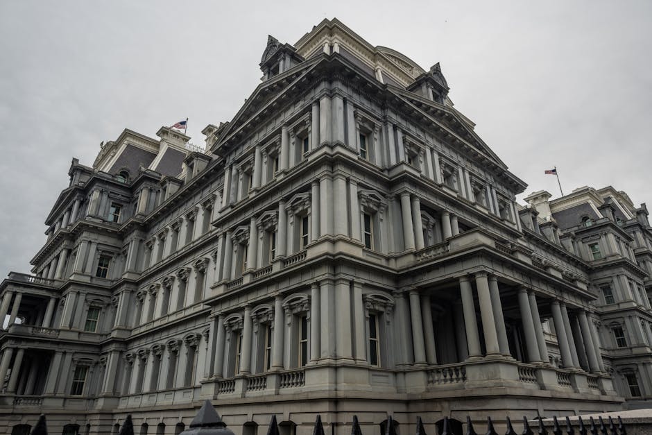 Low angle view of the historic Eisenhower Executive Office Building in Washington, DC, under overcast skies.