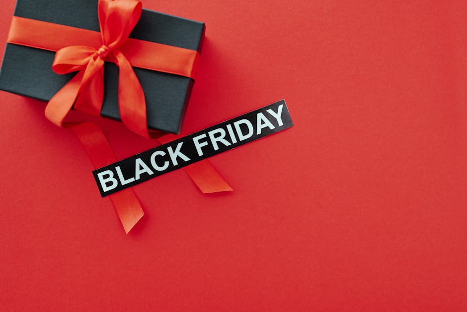 Black Friday sale concept with a gift box and red ribbon on vibrant red background, ideal for promotional use.