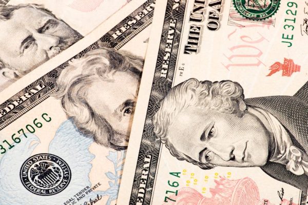 Detailed close-up shot of US dollar bills showing various denominations.