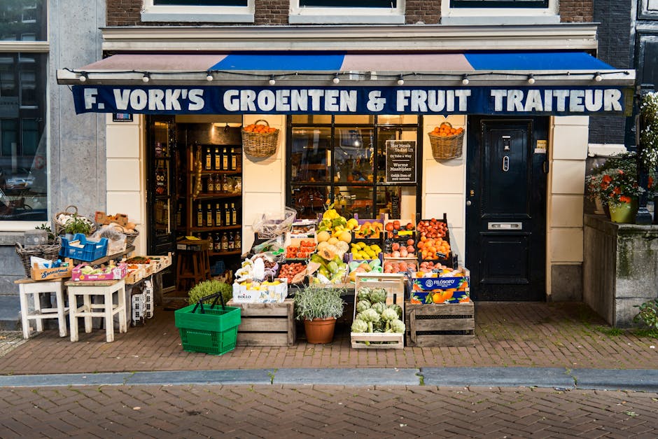 Colorful fruit and vegetable display outside a traditional Amsterdam grocery store.