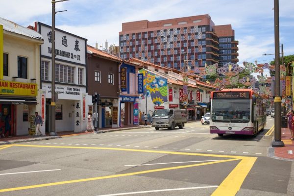 Colorful street with shops and public bus in Singapore's Little India district.