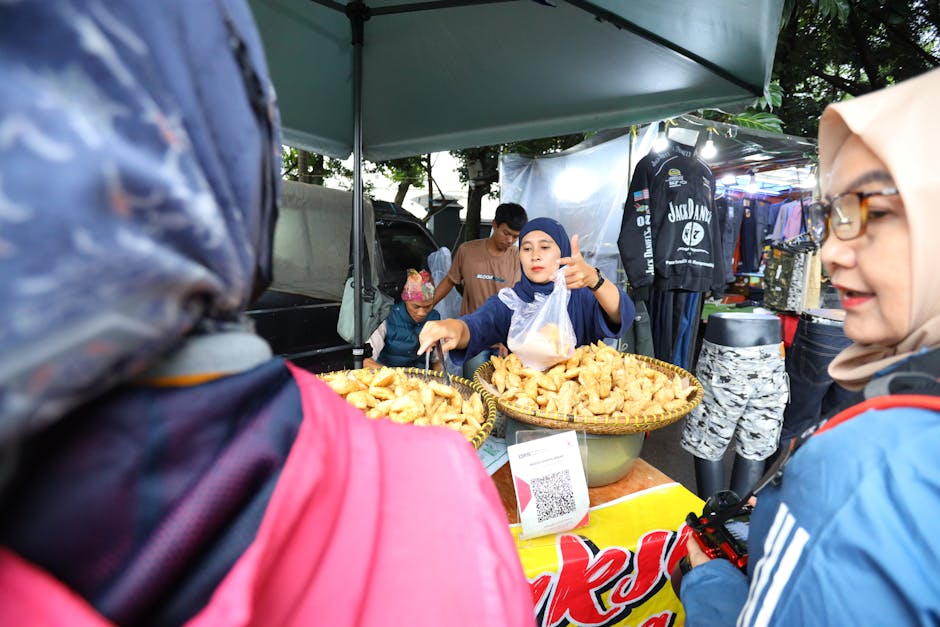 Vibrant street market scene in Jawa Barat with vendor selling local snacks.