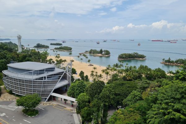 A scenic aerial view of Sentosa Island, showcasing beaches and lush greenery.