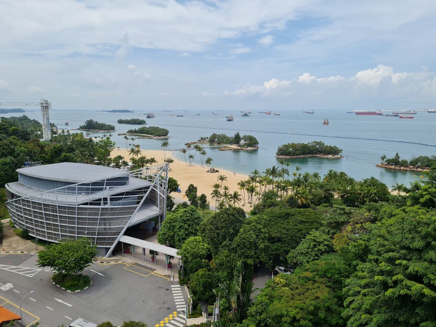 A scenic aerial view of Sentosa Island, showcasing beaches and lush greenery.