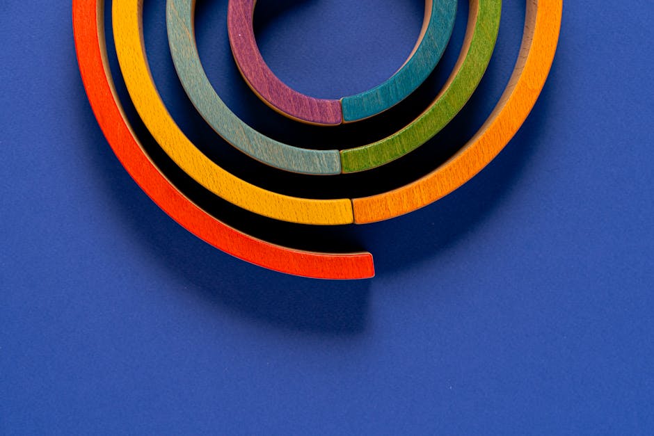 Close-up of multicolored wooden circles on a vibrant blue background in a studio setting.
