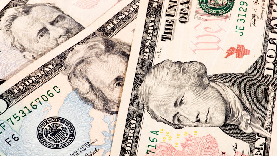 Detailed close-up shot of US dollar bills showing various denominations.