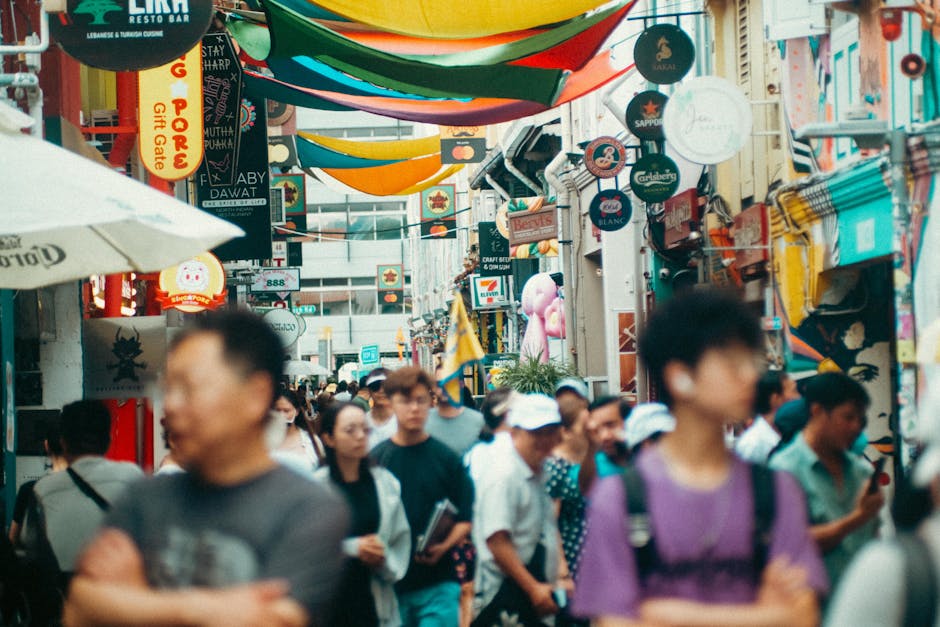Crowded and colorful street in Haji Lane, Singapore, showcasing diverse city life.