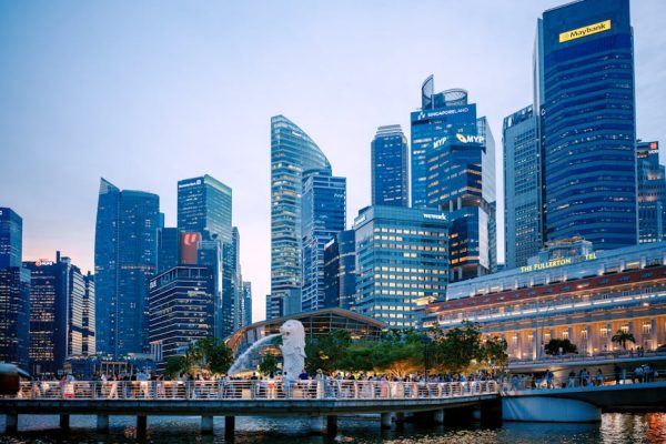 Captured at dusk, this image showcases Singapore's skyline with the iconic Merlion and modern skyscrapers.
