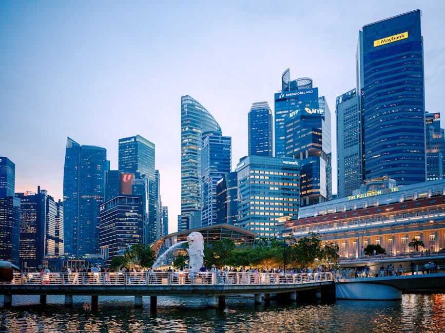Captured at dusk, this image showcases Singapore's skyline with the iconic Merlion and modern skyscrapers.