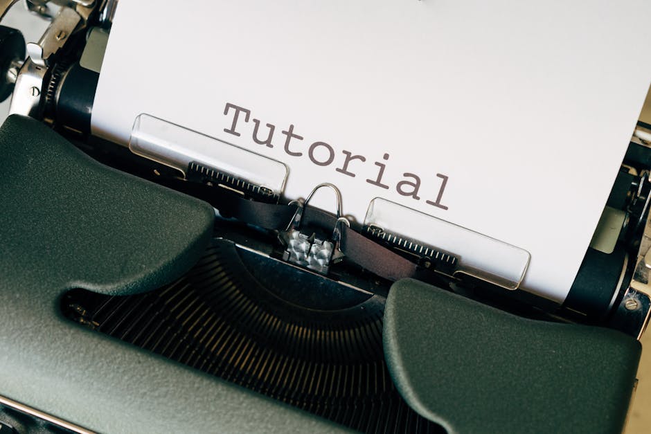 Close-up shot of a vintage typewriter with the word 'Tutorial' typed on paper.