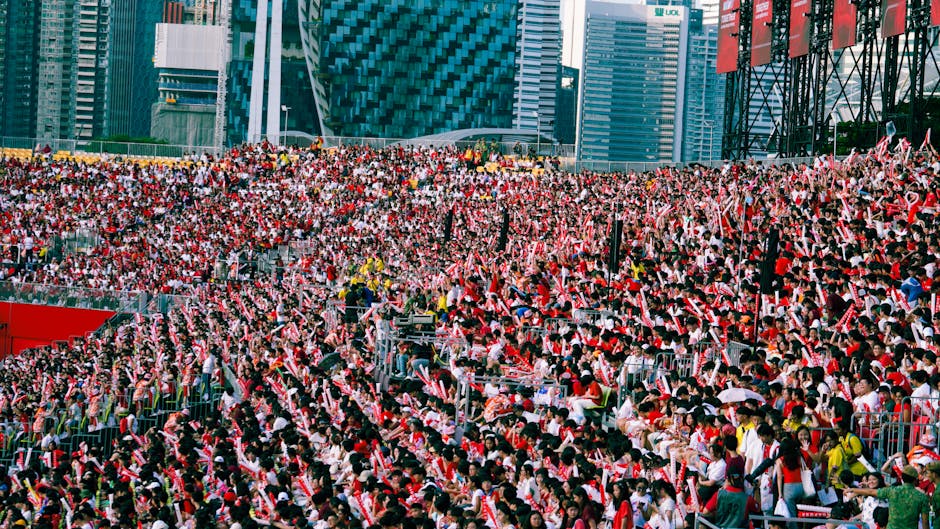 A lively crowd in a stadium during Singapore's National Day Parade.