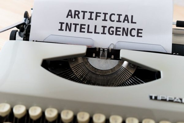 A close-up of a typewriter showcasing 'ARTIFICIAL INTELLIGENCE' on paper.