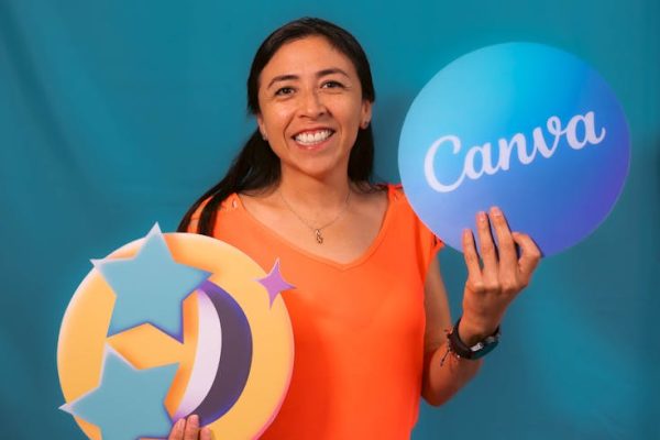 Portrait of a cheerful woman holding Canva logos, perfect for branding content.