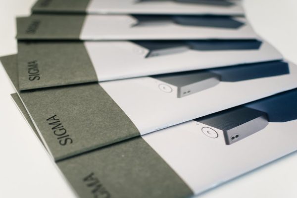 Close-up of folded Sigma brochures showcasing product images and design, ideal for marketing.