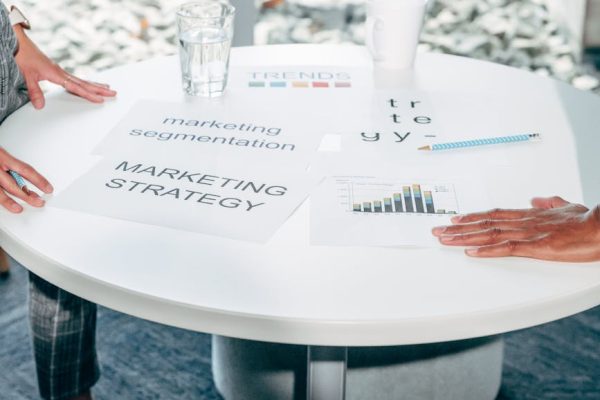 Two professionals collaborate on marketing strategy and segmentation at a round table.