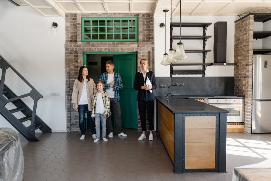 A family with a realtor viewing a modern industrial-style kitchen in a new home.