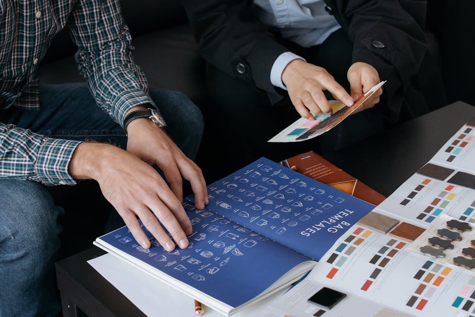 Close-up of designers reviewing bag templates and color swatches at a workspace.