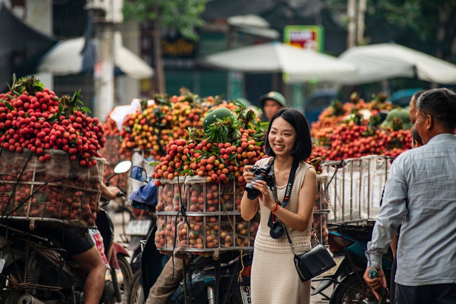 A vibrant street scene in Bac Giang, Vietnam with lychee vendors and a happy photographer capturing the moment.
