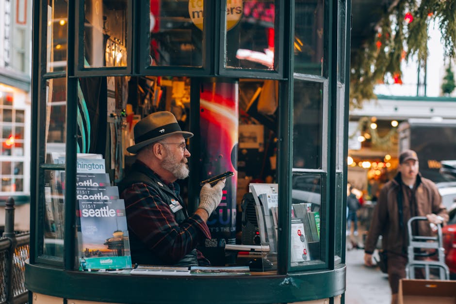 Man in Seattle's iconic visitor booth offering tourist information and brochures.