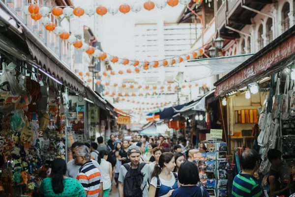 Vibrant street scene capturing the lively atmosphere of Chinatown market in Singapore.