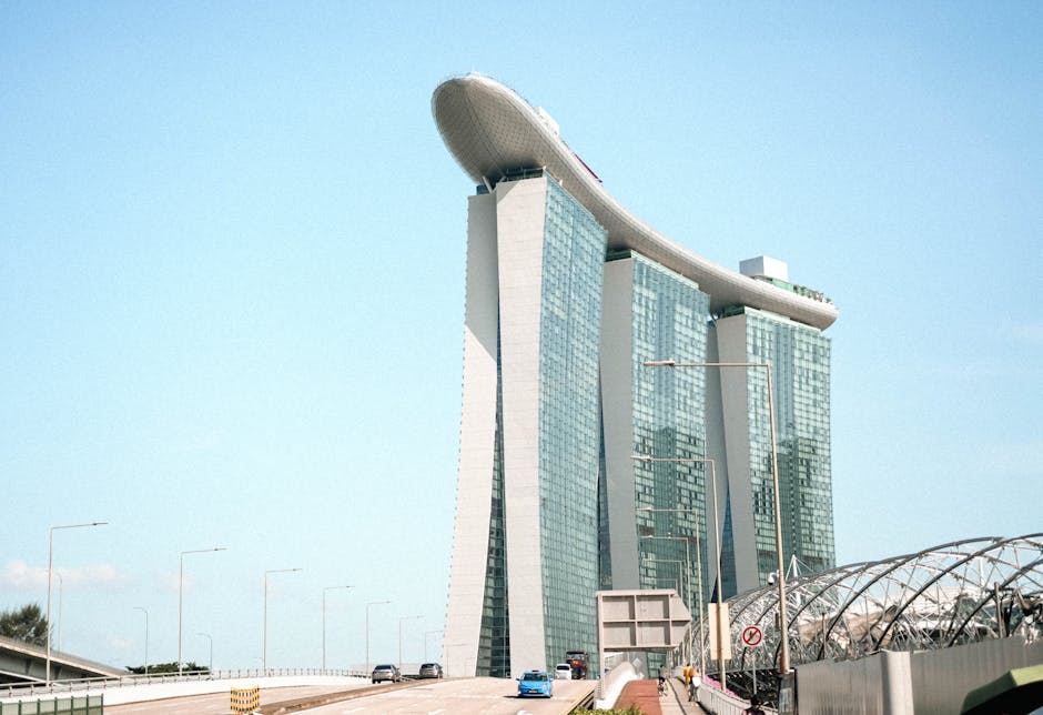 A clear daytime view of Marina Bay Sands in Singapore, showcasing its iconic architecture against a blue sky.