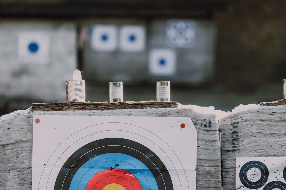 Close-up of archery targets and steel cans used for target practice at an outdoor range.