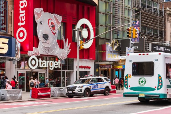 Vibrant street scene in Times Square featuring Target storefront and NYPD car, New York City.