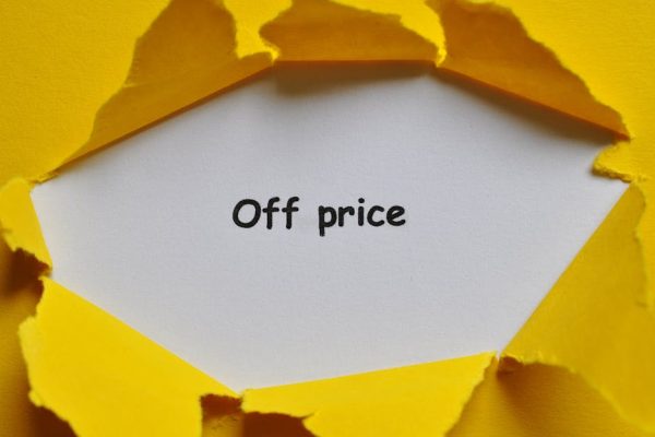 Yellow paper torn open to reveal 'Off Price' text, perfect for sales and discounts concept.