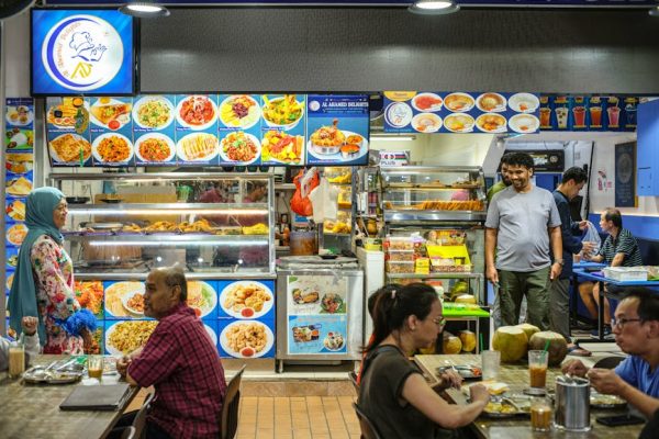 Vibrant Singapore hawker center with diverse food offerings, showcasing a lively dining atmosphere.