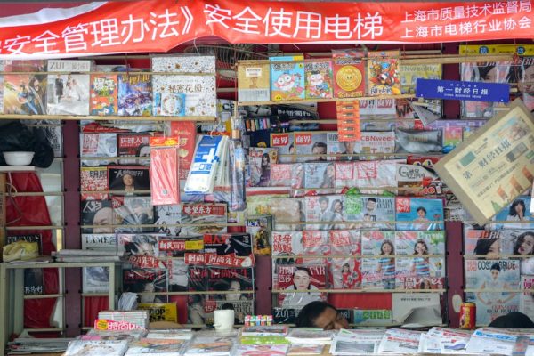 Vibrant newsstand in China displaying a variety of magazines and newspapers.