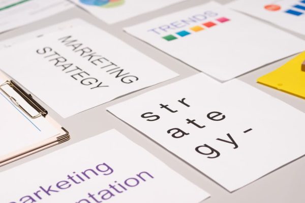 A top view of marketing strategy documents and graphs arranged on a desk, showcasing business planning.