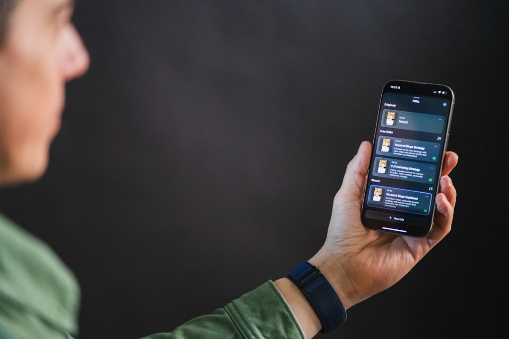 Man holding smartphone with app interface