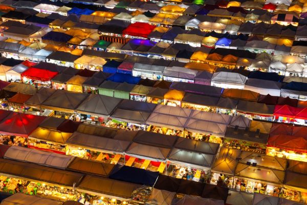 Colorful aerial shot of a bustling night market in Bangkok, Thailand, showcasing vibrant stalls.