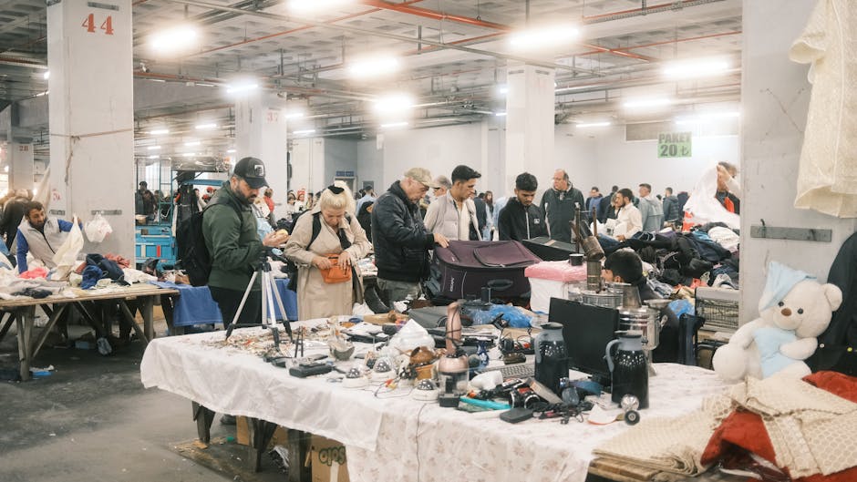 Bargain hunters explore diverse items at an indoor flea market in İstanbul, Türkiye.