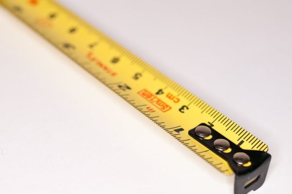 Detailed close-up image of a yellow measuring tape with metric markings.