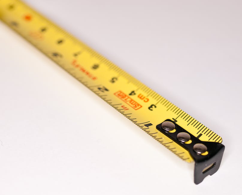 Detailed close-up image of a yellow measuring tape with metric markings.