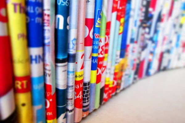 Vibrant, assorted rolled magazines create a colorful display.
