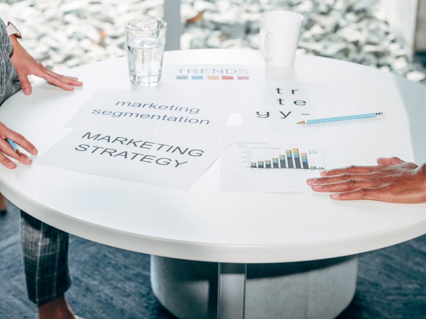 Two professionals collaborate on marketing strategy and segmentation at a round table.