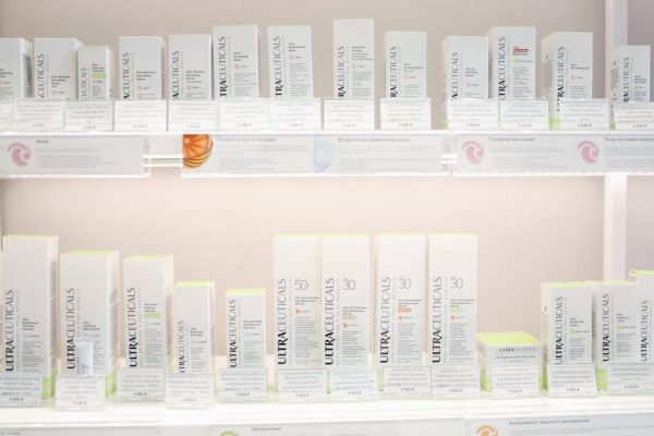 Neatly arranged Ultraceuticals skincare products on bright store shelves.
