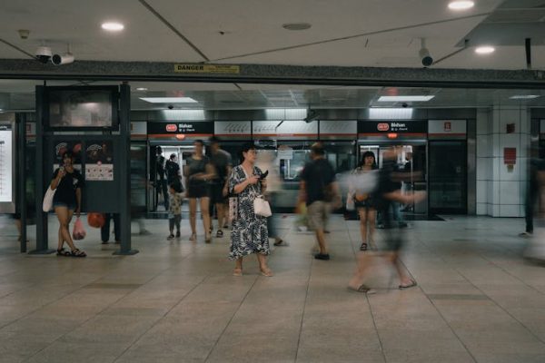 A crowded Bishan MRT station with commuters moving through the transit area.