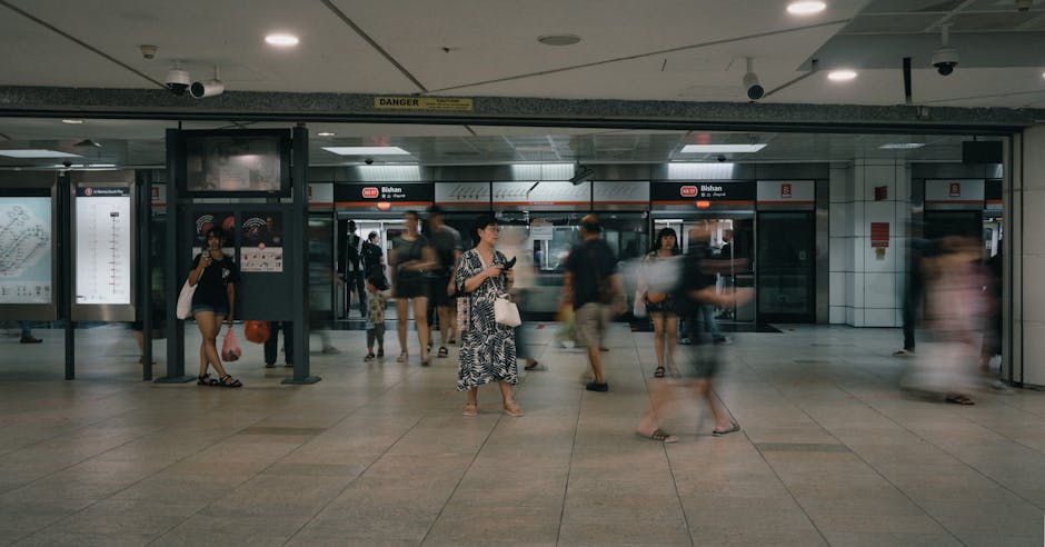 A crowded Bishan MRT station with commuters moving through the transit area.