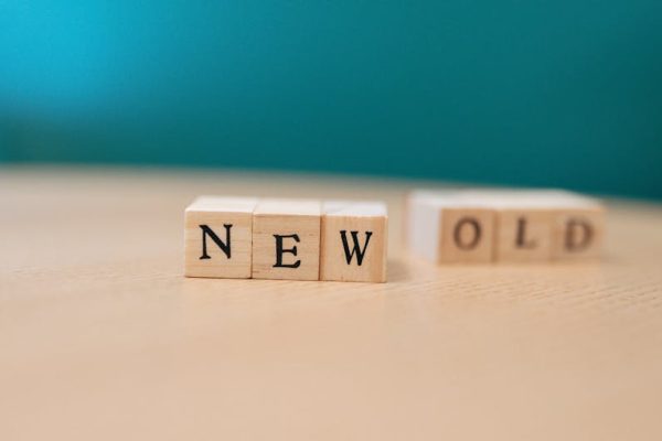 Wooden blocks displaying the words 'NEW' and 'OLD', symbolizing change.