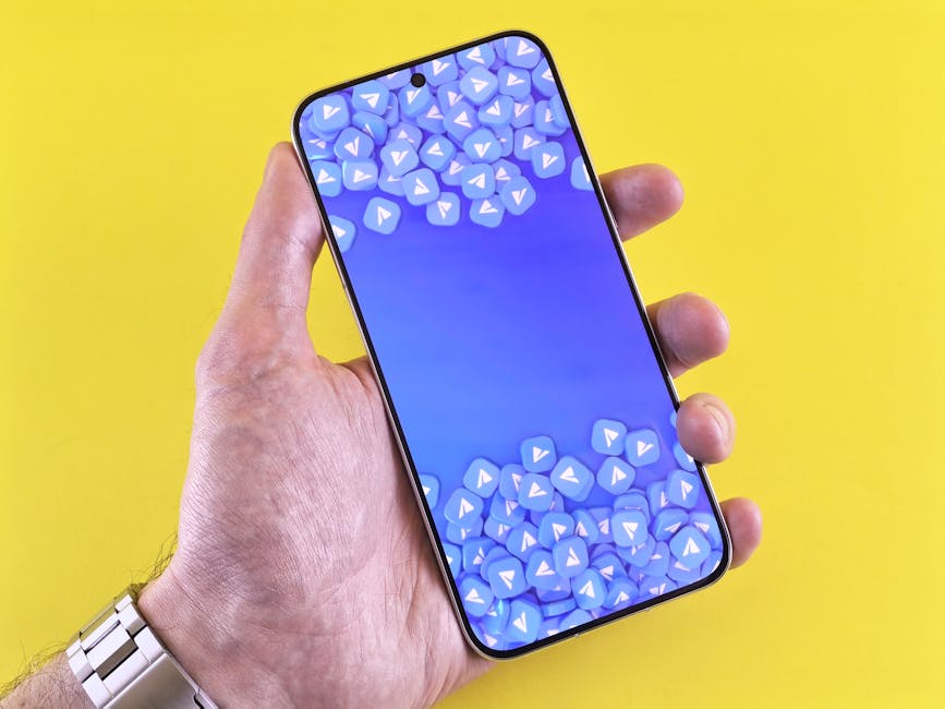 Smartphone displaying social media icons, held in a hand against a bright yellow background.