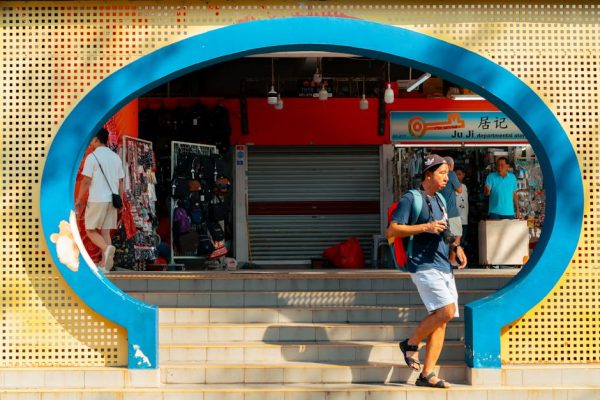 A colorful glimpse of daily life in Singapore's Chinatown with vivid architecture and bustling people.